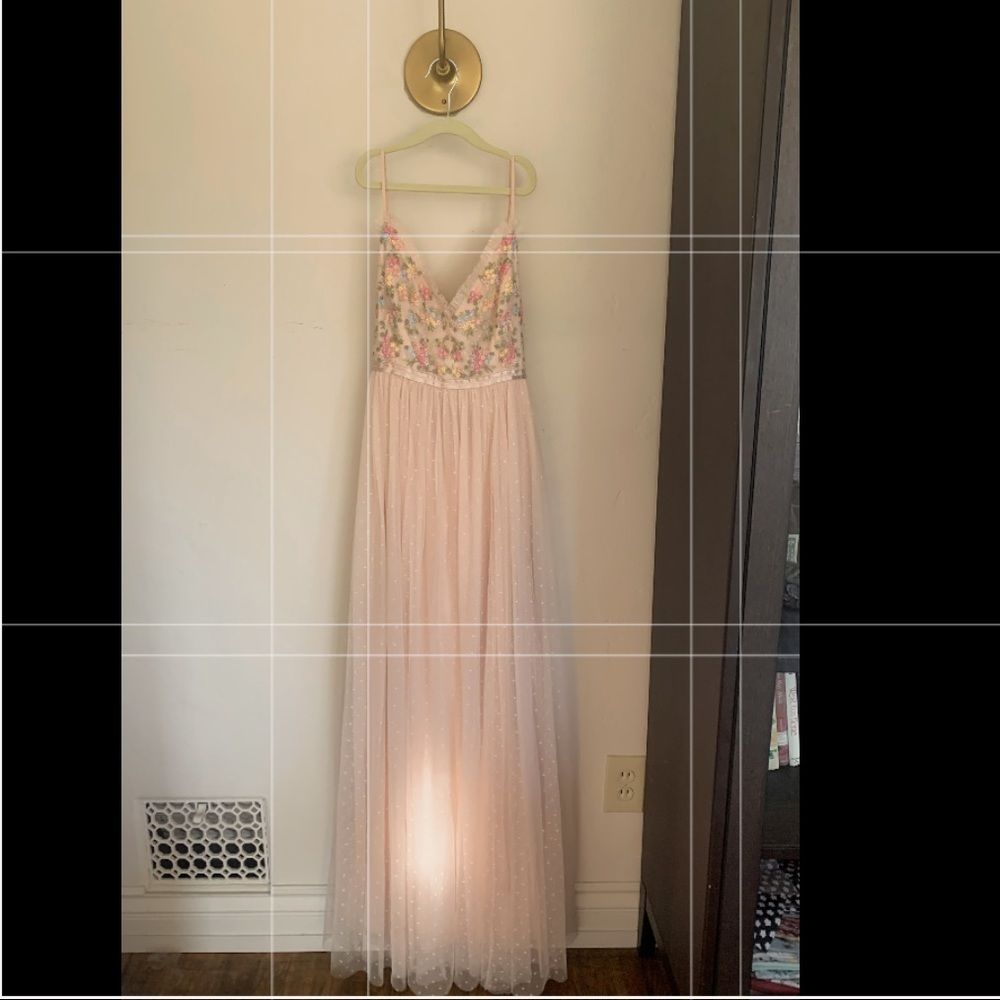 Long dress with flowers on the bust and tulle on the bottom.